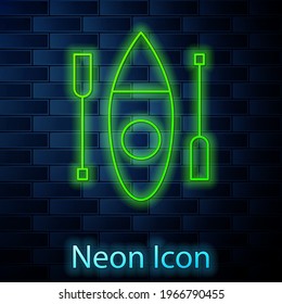 Glowing neon line Kayak and paddle icon isolated on brick wall background. Kayak and canoe for fishing and tourism. Outdoor activities.  Vector