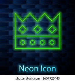 Glowing neon line King crown icon isolated on brick wall background.  Vector Illustration