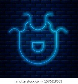 Glowing neon line Kitchen apron icon isolated on brick wall background. Chef uniform for cooking.  Vector Illustration