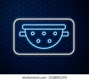 Glowing neon line Kitchen colander icon isolated on brick wall background. Cooking utensil. Cutlery sign.  Vector