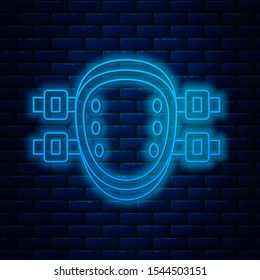 Glowing neon line Knee pads icon isolated on brick wall background. Extreme sport. Sport equipment. Skateboarding, bicycle, roller skating protective gear.  Vector Illustration