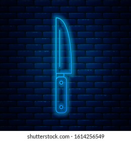 Glowing neon line Knife icon isolated on brick wall background. Cutlery symbol.  Vector Illustration