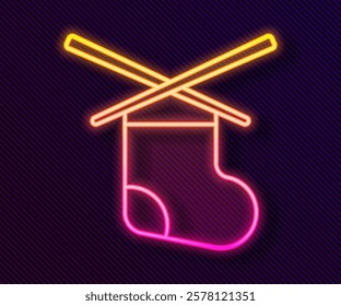 Glowing neon line Knitting needles icon isolated on black background. Label for hand made, knitting or tailor shop.  Vector