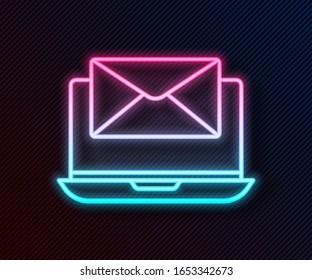 Glowing neon line Laptop with envelope and open email on screen icon isolated on black background. Email marketing, internet advertising concepts.  Vector Illustration