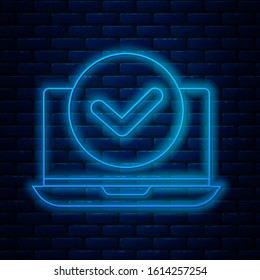 Glowing neon line Laptop icon isolated on brick wall background. Computer notebook with empty screen sign.  Vector Illustration