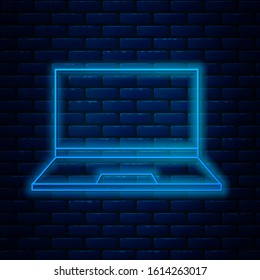 Glowing neon line Laptop icon isolated on brick wall background. Computer notebook with empty screen sign.  Vector Illustration