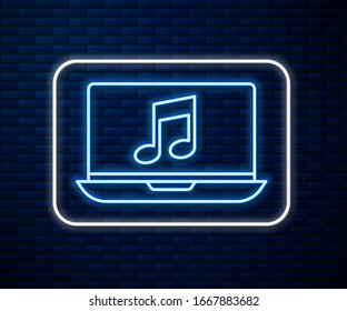 Glowing neon line Laptop with music note symbol on screen icon isolated on brick wall background.  Vector Illustration