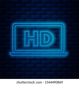 Glowing neon line Laptop screen with HD video technology icon isolated on brick wall background.  Vector Illustration