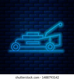 Glowing neon line Lawn mower icon isolated on brick wall background. Lawn mower cutting grass.  Vector Illustration