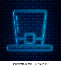 Glowing neon line Leprechaun hat icon isolated on brick wall background. Happy Saint Patricks day.  Vector Illustration