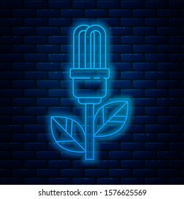 Glowing neon line Light bulb with leaf icon isolated on brick wall background. Eco energy concept. Alternative energy concept.  Vector Illustration