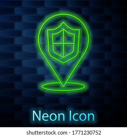 Glowing neon line Location shield icon isolated on brick wall background. Insurance concept. Guard sign. Security, safety, protection, privacy concept. Vector.