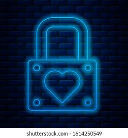 Glowing neon line Lock and heart icon isolated on brick wall background. Locked Heart. Love symbol and keyhole sign. Valentines day symbol.  Vector Illustration