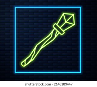 Glowing neon line Magic staff icon isolated on brick wall background. Magic wand, scepter, stick, rod.  Vector