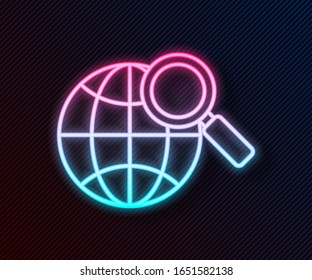 Glowing neon line Magnifying glass with globe icon isolated on black background. Analyzing the world. Global search sign.  Vector Illustration