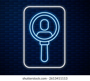 Glowing neon line Magnifying glass for search a people icon isolated on brick wall background. Recruitment or selection. Search for employees and job.  Vector