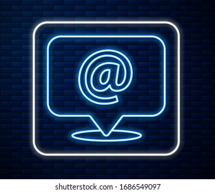 Glowing neon line Mail and e-mail icon isolated on brick wall background. Envelope symbol e-mail. Email message sign.  Vector Illustration