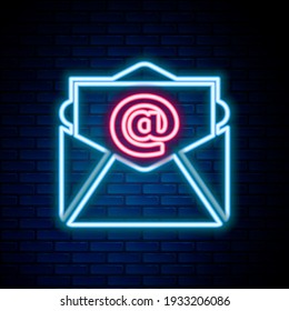 Glowing neon line Mail and e-mail icon isolated on brick wall background. Envelope symbol e-mail. Email message sign. Colorful outline concept. Vector