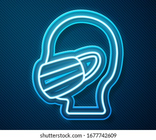 Glowing neon line Man face in a medical protective mask icon isolated on blue background. Quarantine.  Vector Illustration