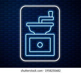 Glowing neon line Manual coffee grinder icon isolated on brick wall background.  Vector