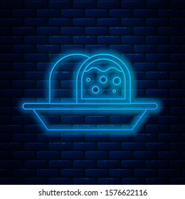 Glowing neon line Marzipan sponge cake icon isolated on brick wall background. Merry Christmas and Happy New Year.  Vector Illustration