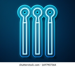 Glowing neon line Matches icon isolated on blue background.  Vector Illustration