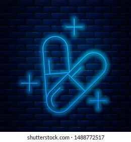 Glowing neon line Medicine pill or tablet icon isolated on brick wall background. Capsule pill and drug sign. Pharmacy design.  Vector Illustration