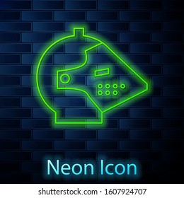 Glowing neon line Medieval iron helmet for head protection icon isolated on brick wall background.  Vector Illustration