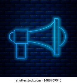 Glowing neon line Megaphone icon isolated on brick wall background. Loud speach alert concept. Bullhorn for Mouthpiece scream promotion.  Vector Illustration