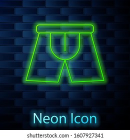 Glowing neon line Men underpants icon isolated on brick wall background. Man underwear.  Vector Illustration