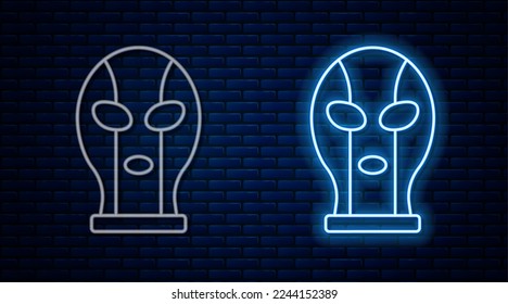 Glowing neon line Mexican wrestler icon isolated on brick wall background.  Vector