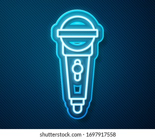 Glowing neon line Microphone icon isolated on blue background. On air radio mic microphone. Speaker sign.  Vector Illustration