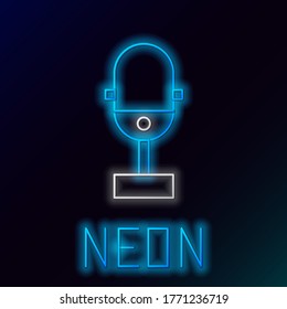 Glowing neon line Microphone icon isolated on black background. On air radio mic. Microphone sign. Colorful outline concept. Vector