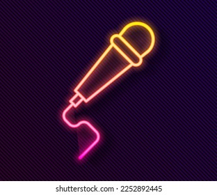 Glowing neon line Microphone icon isolated on black background. On air radio mic microphone. Speaker sign.  Vector Illustration