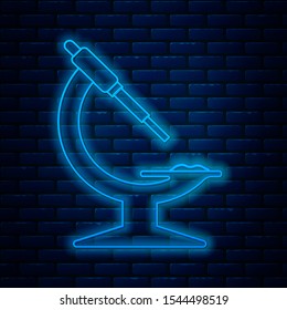 Glowing neon line Microscope icon isolated on brick wall background. Chemistry, pharmaceutical instrument, microbiology magnifying tool.  Vector Illustration