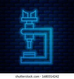 Glowing neon line Microscope icon isolated on brick wall background. Chemistry, pharmaceutical instrument, microbiology magnifying tool.  Vector Illustration