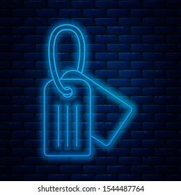 Glowing neon line Military dog tag icon isolated on brick wall background. Identity tag icon. Army sign.  Vector Illustration
