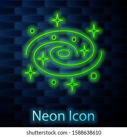 Glowing neon line Milky way spiral galaxy with stars icon isolated on brick wall background.  Vector Illustration