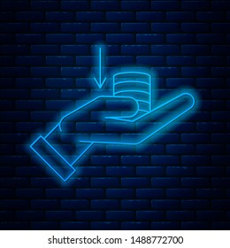 Glowing neon line Money on hand icon isolated on brick wall background. Palm holds cash with down. Cash salary decrease. Vector Illustration Glowing neon line Money on hand icon isolated on brick wall background. Palm holds cash with down. Cash salary decrease. Vector Illustration