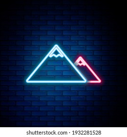 Glowing neon line Mountains icon isolated on brick wall background. Symbol of victory or success concept. Colorful outline concept. Vector