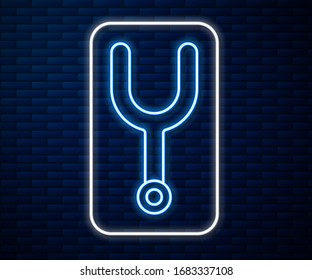 Glowing neon line Musical tuning fork for tuning musical instruments icon isolated on brick wall background.  Vector Illustration