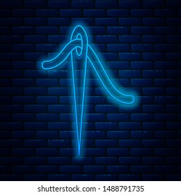 Glowing neon line Needle for sewing with thread icon isolated on brick wall background. Tailor symbol. Textile sew up craft sign. Embroidery tool.  Vector Illustration