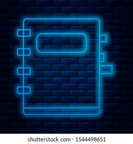 Glowing neon line Notebook icon isolated on brick wall background. Spiral notepad icon. School notebook. Writing pad. Diary for school.  Vector Illustration