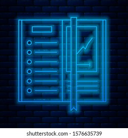 Glowing neon line Notebook icon isolated on brick wall background. Spiral notepad icon. Writing pad. Diary for business. Notebook cover design.  Vector Illustration