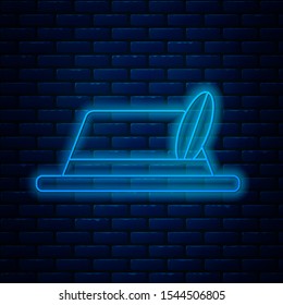 Glowing neon line Oktoberfest hat icon isolated on brick wall background. Hunter hat with feather. German hat.  Vector Illustration