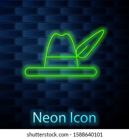 Glowing neon line Oktoberfest hat icon isolated on brick wall background. Hunter hat with feather. German hat.  Vector Illustration