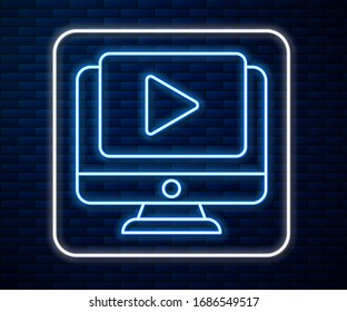 Glowing neon line Online play video icon isolated on brick wall background. Computer monitor and film strip with play sign.  Vector Illustration