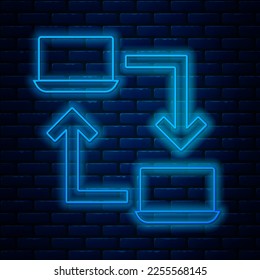 Glowing neon line Online working icon isolated on brick wall background. Freelancer man working on laptop at his house. Remote work. Distant job concept.  Vector