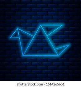 Glowing neon line Origami bird icon isolated on brick wall background.  Vector Illustration