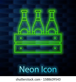 Glowing neon line Pack of beer bottles icon isolated on brick wall background. Wooden box and beer bottles. Case crate beer box sign.  Vector Illustration